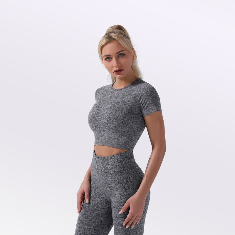 Woman wearing a women's seamless yoga set in gray, suitable for fitness exercise and various seasons.