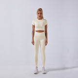 Women wearing women's seamless yoga set in cream color for fitness and exercise.